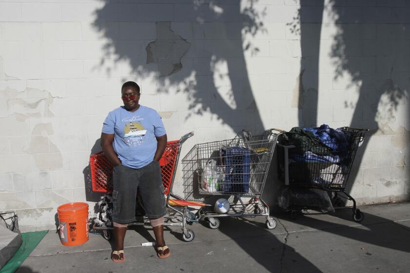 Annie Moody stands next to her tent on Towne Avenue at 6th Street in the skid row area of Los Angeles.