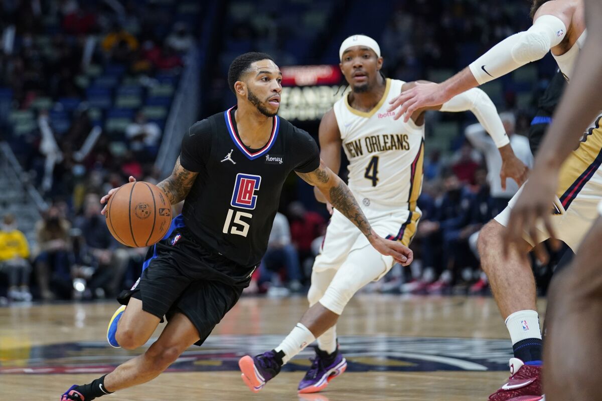 Clippers guard Xavier Moon drives the lane past New Orleans Pelicans guard Devonte' Graham during a Clippers loss on Jan. 13.