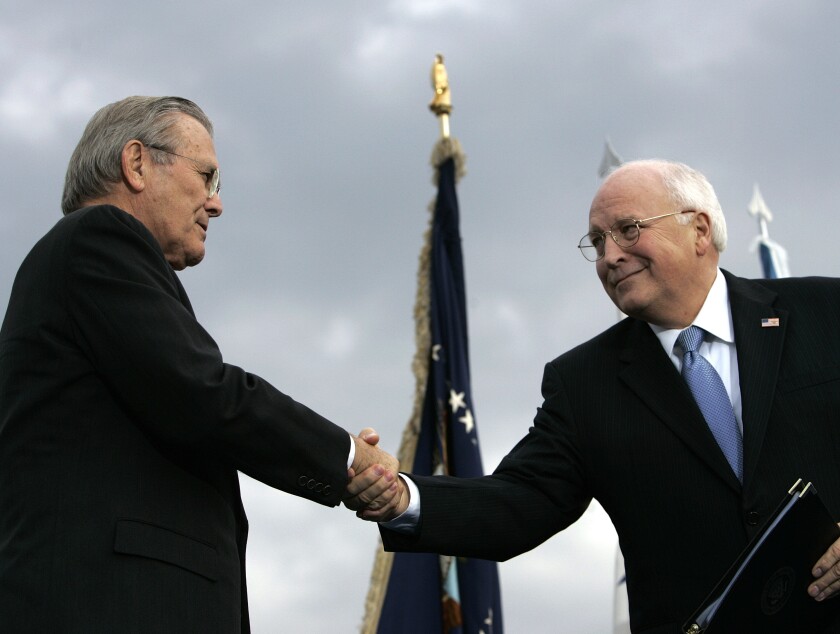  In this 2006 file photo, outgoing Defense Secretary Donald H. Rumsfeld shakes hands with Vice President Dick Cheney.
