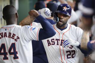 Houston Astros' Yordan Alvarez (44) and Jason Heyward (22) celebrate in the dugout after Heyward's two-run home run against the Oakland Athletics during the second inning of a baseball game Thursday, Sept. 12, 2024, in Houston. (AP Photo/Michael Wyke)