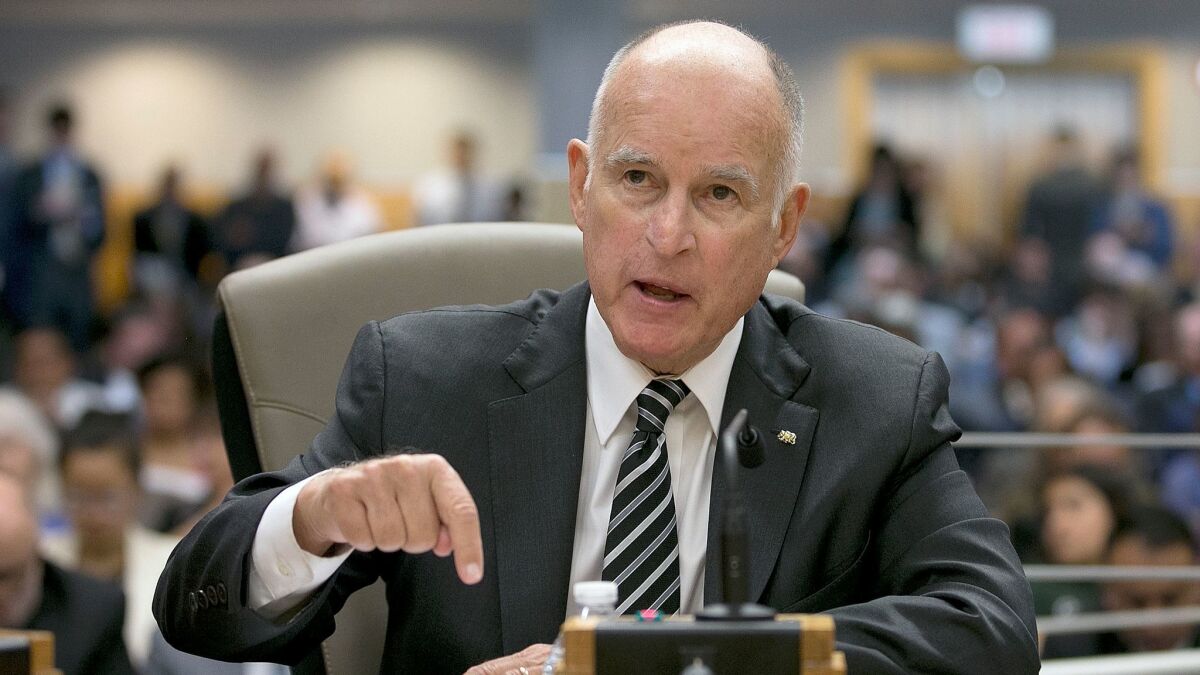 Gov. Jerry Brown responds to a question while testifying in support of extending the state's cap-and-trade program during a hearing of the Senate Environmental Quality committee.