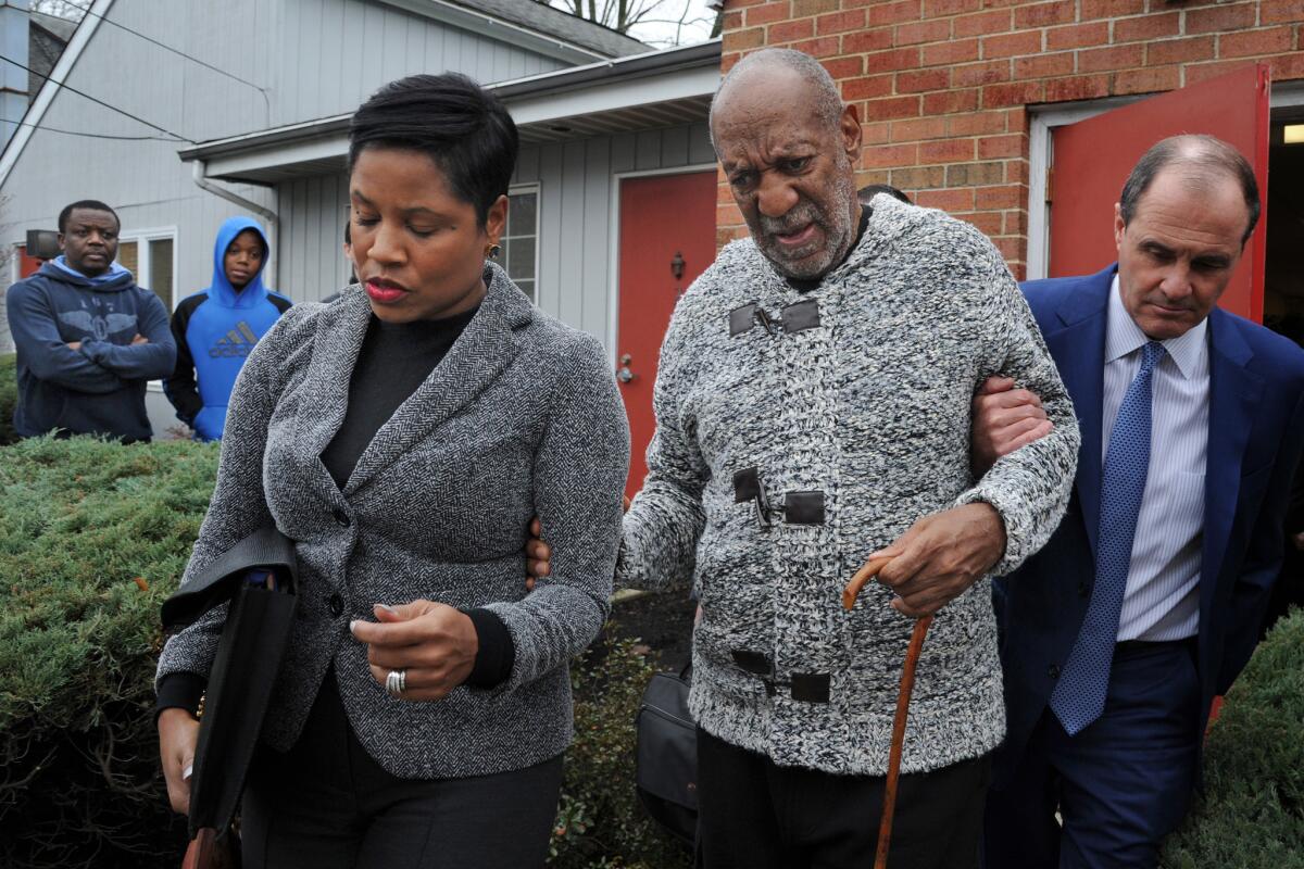 Actor and comedian Bill Cosby is helped as he leaves after a court appearance on Dec. 30 in Elkins Park, Pa.