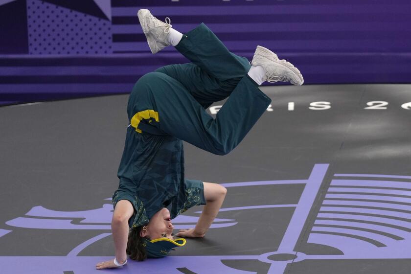 Australia's Rachael Gunn, known as B-Girl Raygun, stands on her head during the breaking competition 2024 Paris Olympics