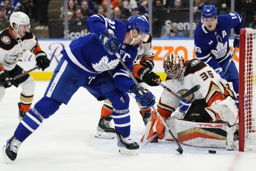 Anaheim Ducks' goaltender John Gibson (36) makes a save on Toronto Maple Leafs' John Tavares (91) during the second period of an NHL hockey game in Toronto on Tuesday, Dec. 13, 2022. (Frank Gunn/The Canadian Press via AP)