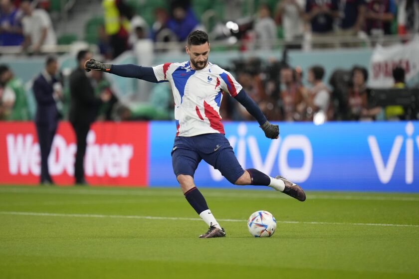 France's goalkeeper Hugo Lloris kicks the ball during warm up ahead of the World Cup round of 16 soccer match between France and Poland, at the Al Thumama Stadium in Doha, Qatar, Sunday, Dec. 4, 2022. (AP Photo/Moises Castillo)