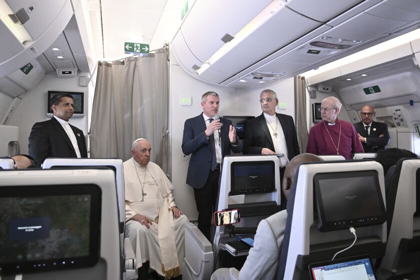 The Archbishop of Canterbury Justin Welby, right, Pope Francis,left, and the Moderator of the General Assembly of the Church of Scotland Iain Greenshields meet the journalists during an airborne press conference aboard the airplane directed to Rome, at the end of his pastoral visit to Congo and South Sudan, Sunday, Feb. 5, 2023. (Tiziana Fabi/Pool Photo Via AP)