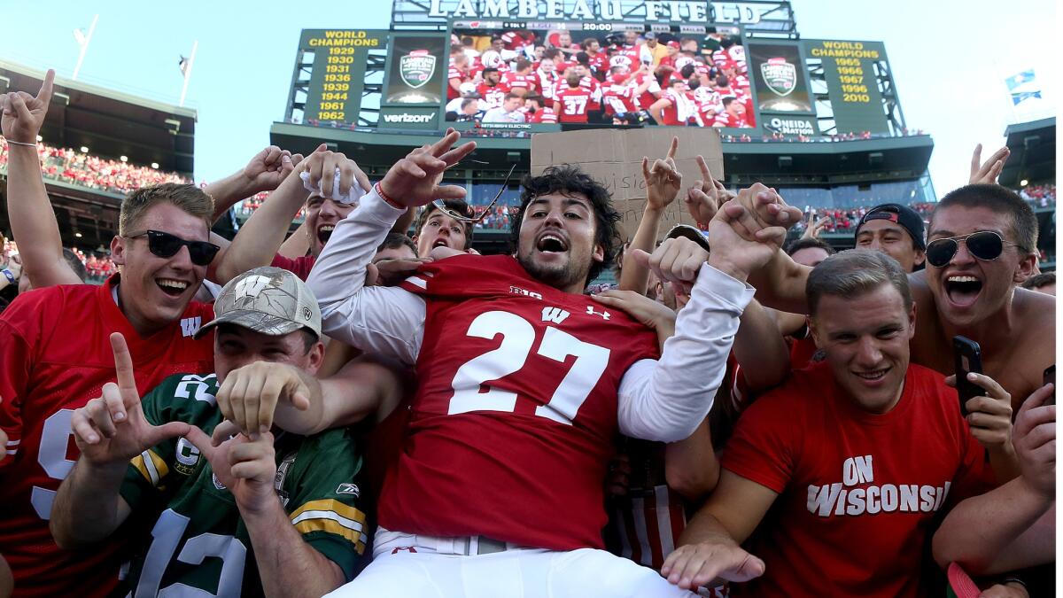 Kicker Rafael Gaglianone celebrates with fans after helping Wisconsin upset LSU on Saturday.