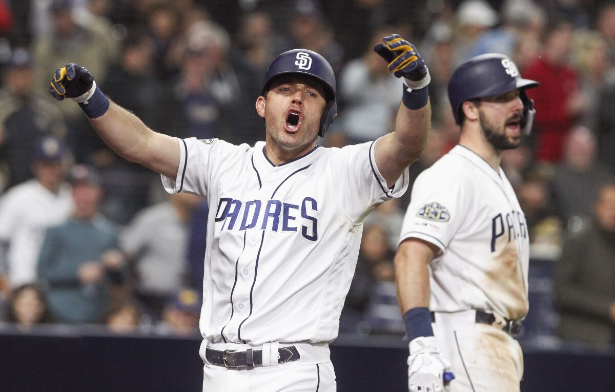 The Padres' Ian Kinsler lets out a yell as he celebrates his three-run home run in the sixth inning against the Pirates at Petco Park on Thursday.