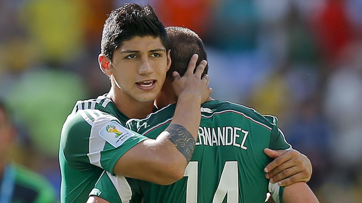 Mexico's Javier Hernandez, right, is consoled by his teammate Alan Pulido after the team's 2-1 loss to the Netherlands in the World Cup Round of 16 on Sunday. Mexico players and its coach say victory was stolen from them.