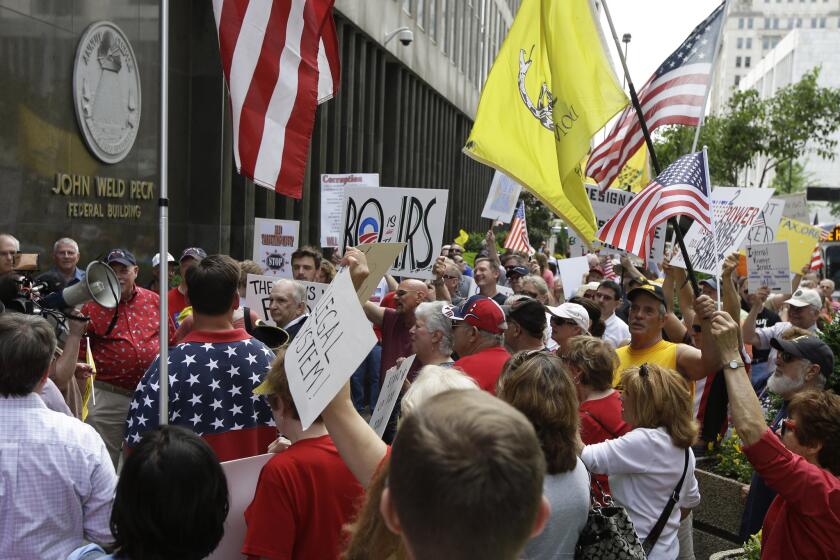 Tea party activists demonstrate outside the John Weld Peck Federal Building in Cincinnati. The building houses the main offices for the Internal Revenue Service in the city and is tied to the targeting of conservative groups.