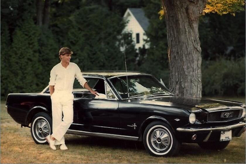 A young Jim Farley, now Ford CEO, with his first car, a 1965 Mustang.