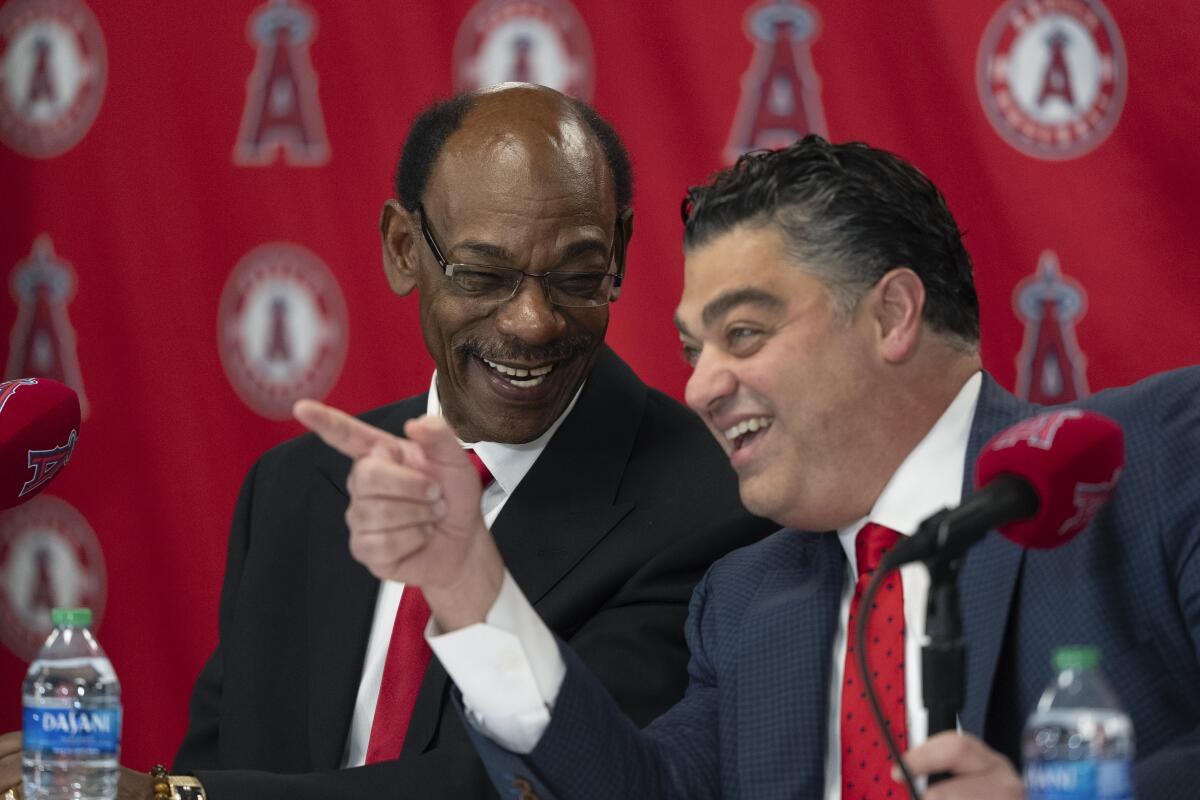 Angels manager Ron Washington, left, and general manager Perry Minasian speak on Nov. 15 in Anaheim.
