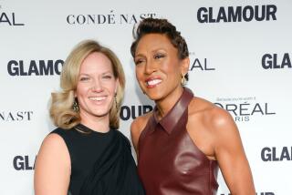 Robin Roberts and girlfriend Amber Laign attend a formal event