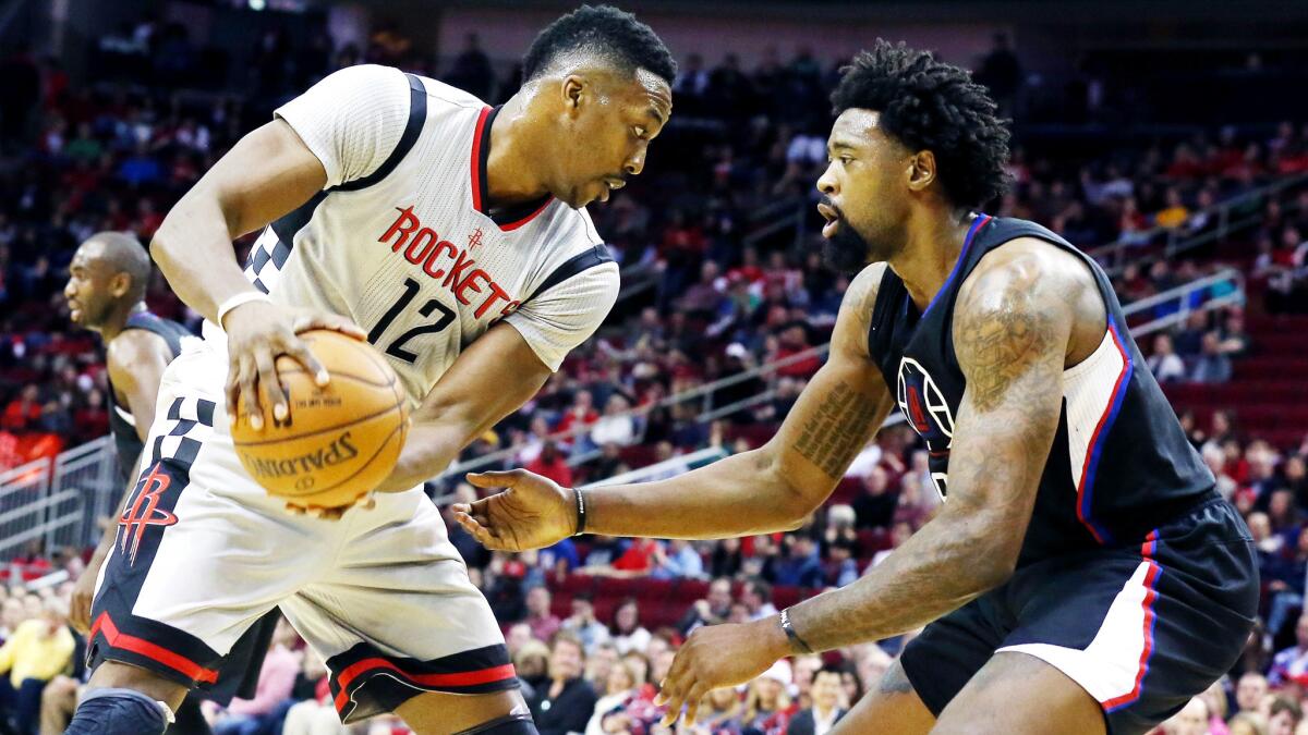 Rockets center Dwight Howard works in the post against Clippers center DeAndre Jordan during their game Saturday in Houston.