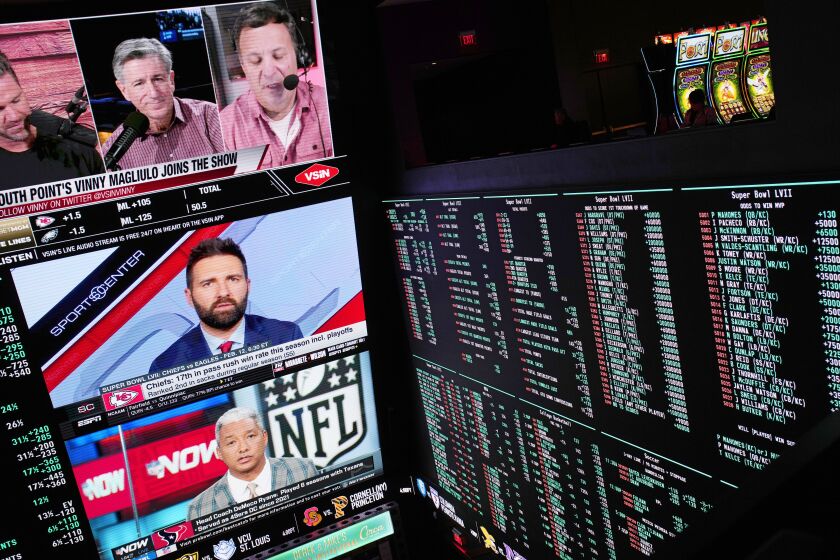 A person gambles as betting odds for NFL football's Super Bowl are displayed on monitors at the Circa resort and casino sports book Friday, Feb. 3, 2023, in Las Vegas. (AP Photo/John Locher)