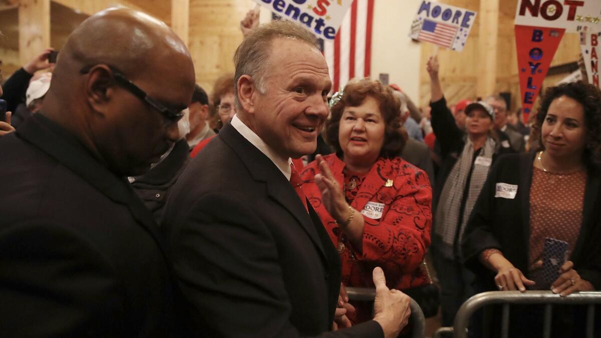 Roy Moore, who has largely disappeared since sexual misconduct allegations surfaced, turned out Monday night for an election eve rally in rural southeastern Alabama.