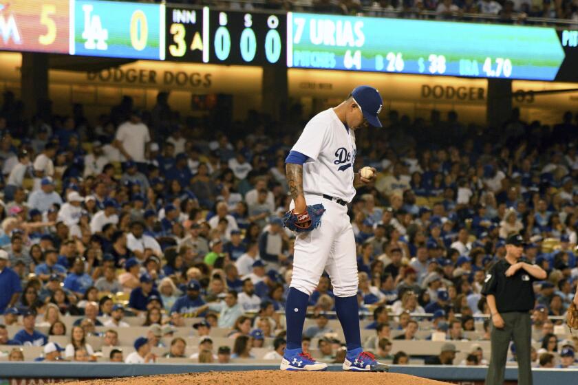 Los Angeles Dodgers pitcher Julio Urias looks down during a rough third inning when the Miami Marlins scored four runs during a baseball game in Los Angeles, Saturday, May 20, 2017. (AP Photo/Michael Owen Baker)