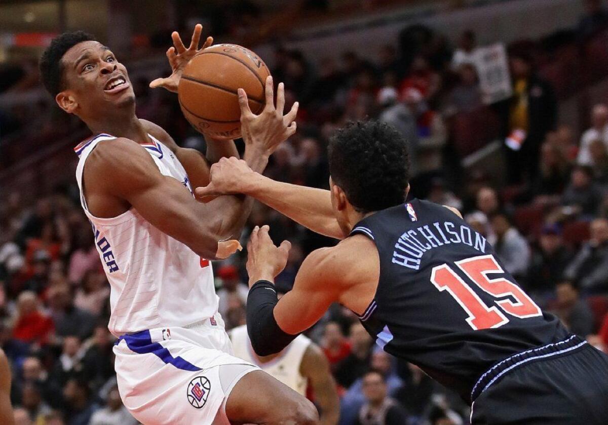 Clippers guard Shai Gilgeous-Alexander tries to put up a shot over Chicago Bulls small forward Chandler Hutchison during a game on Jan. 25.