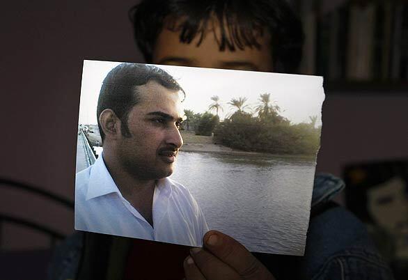 The 6-year-old nephew of Muntather Zaidi, the Iraqi journalist arrested for throwing his shoes at President Bush during a news conference, holds up his uncle's photo at his home in Baghdad. The incident was branded as shameful by the Iraqi government, but many in the Arab world hailed it as an ideal parting gift to the U.S. president, who was making a farewell visit to the country.