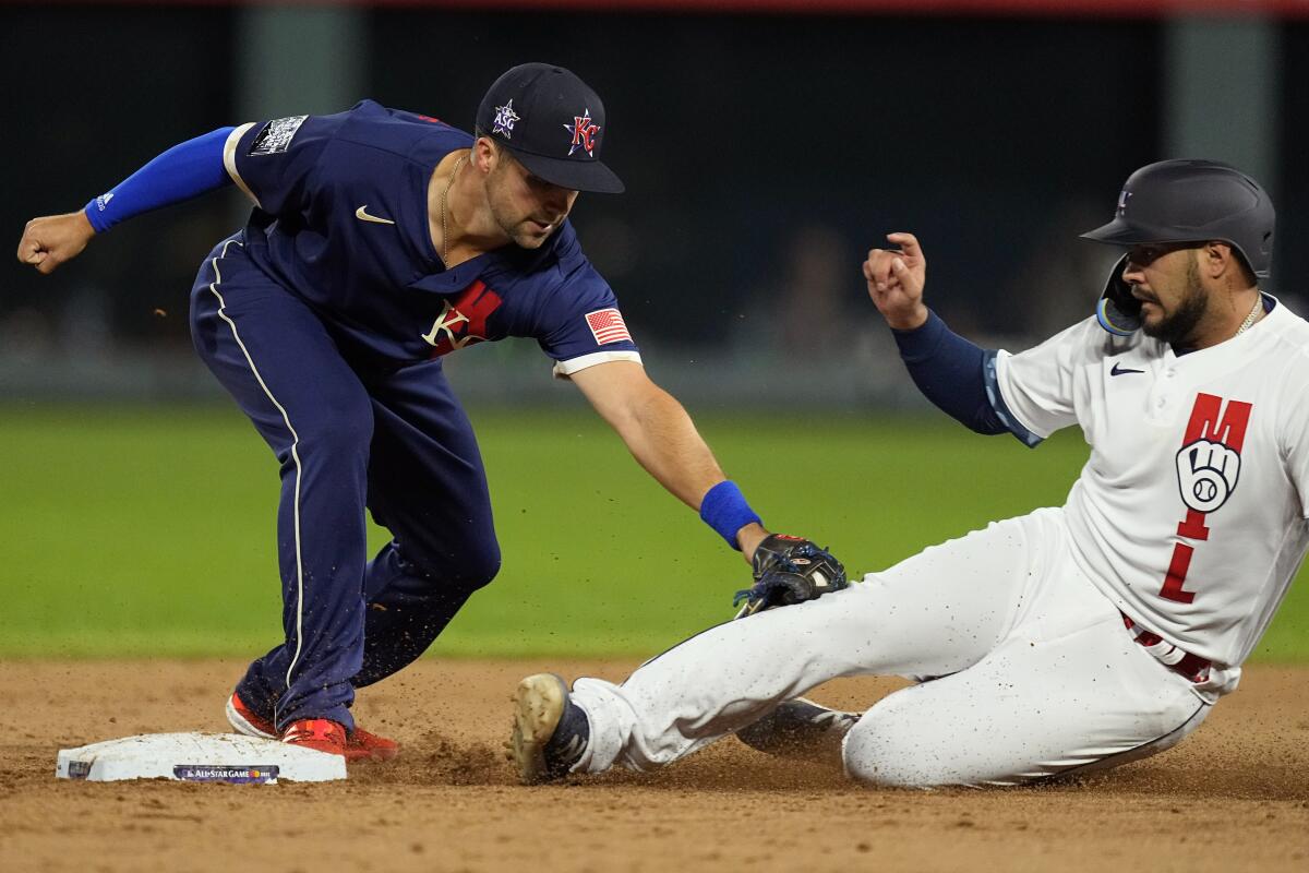 American League's Whit Merrifield tags out National League's Omar Narvaez on a runners fielders choice.
