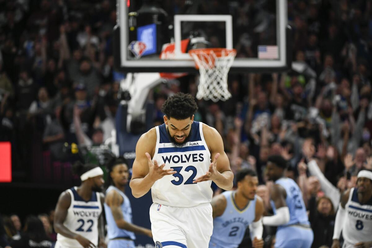 Timberwolves center Karl-Anthony Towns reacts after scoring April 23, 2022.