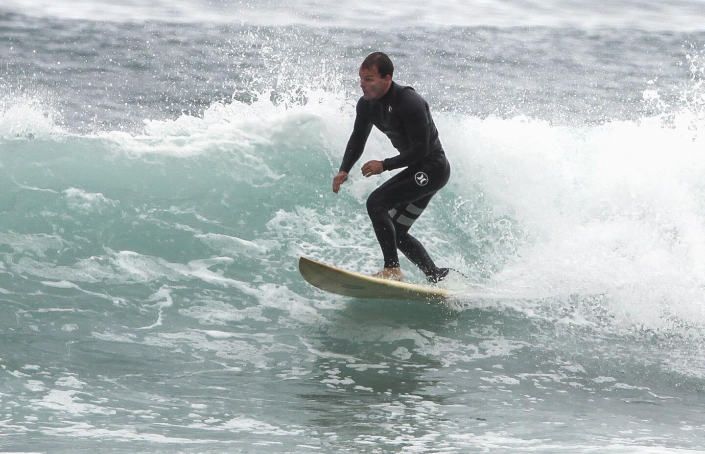After kinesiology students placed eight sensors, or thermistors, used to measure skin temperature, and a heart rate monitor on him, surfer James Petracca, 27, who volunteered to participate in the CSUSM surf study, rides a wave at Swamis.