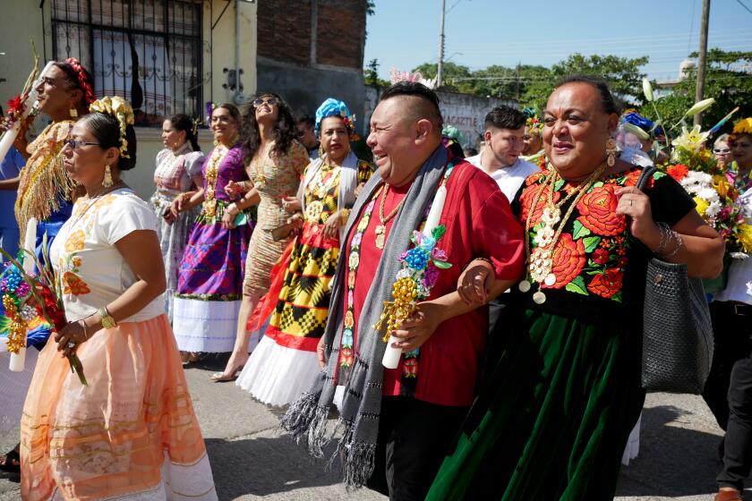 Muxes, Alexis and Misteca proudly march arm-in-arm alongside fellow muxes during street parade in Juchitan de Zaragoza, Oaxaca, Mexico on Nov. 18, 2023. Last weekend, the 48th annual celebration of Mexico's third gender - the 'muxes' - took place in Juchitan de Zaragoza in Mexico, the country with the second-highest number of murders of trans and gender-diverse people so far this year. Muxe - pronounced 'mu-shay' are born biologically male, but live and embody traditional feminine characteristics and roles in their society. The defiant community has been part of the indigenous Zapotec culture in southern Mexico for thousands of years, but recent tragic deaths have begun to plague the muxes. Despite fear, the community prioritized a show of strength in their bid for equal rights and freedom in Mexico.