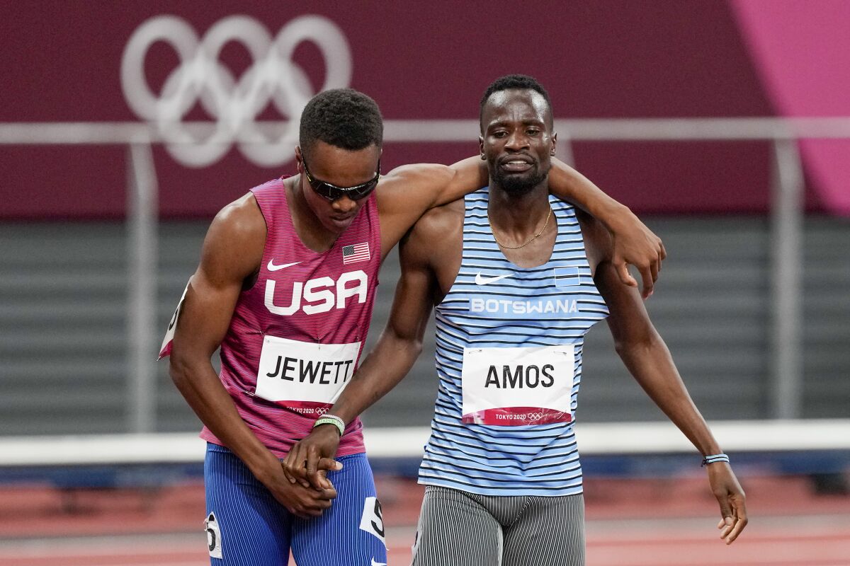 U.S. runner Isaiah Jewett, left, and Nijel Amos of Botswana shake hands after falling in the men's 800-meter semifinal.