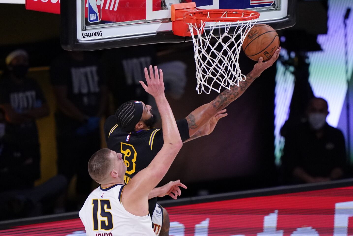 Lakers forward Anthony Davis attempts a reverse layup against Nuggets center Nikola Jokic during Game 2.