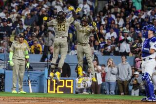 The Padres' Fernando Tatis Jr. celebrates with teammate Jurickson Profar after homering against the Dodgers on Sept. 25