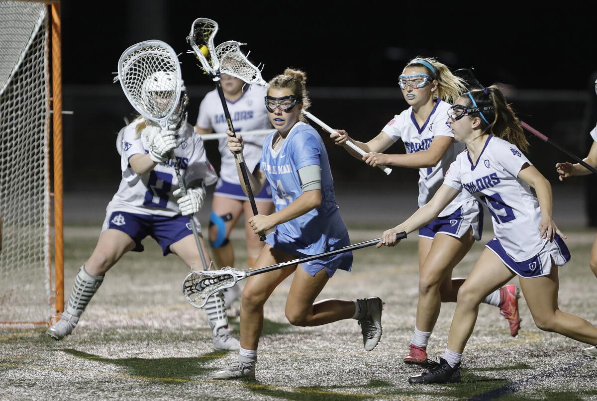 CdM's Belle Grace (24) is met by a host of Newport Harbor defenders during Battle of the Bay girls' lacrosse on Thursday.