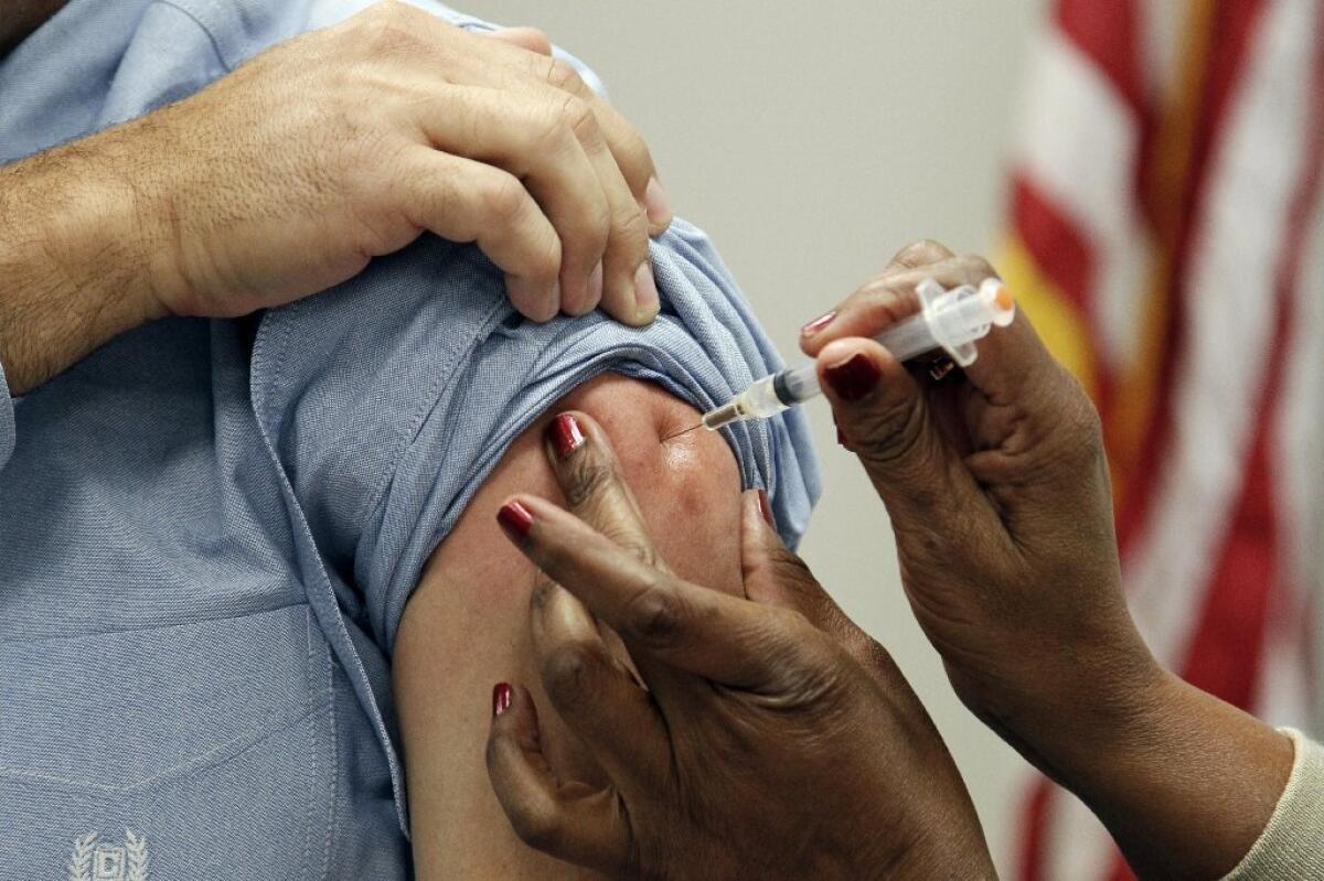A patient receives a flu vaccination in Jackson, Miss., in 2012.