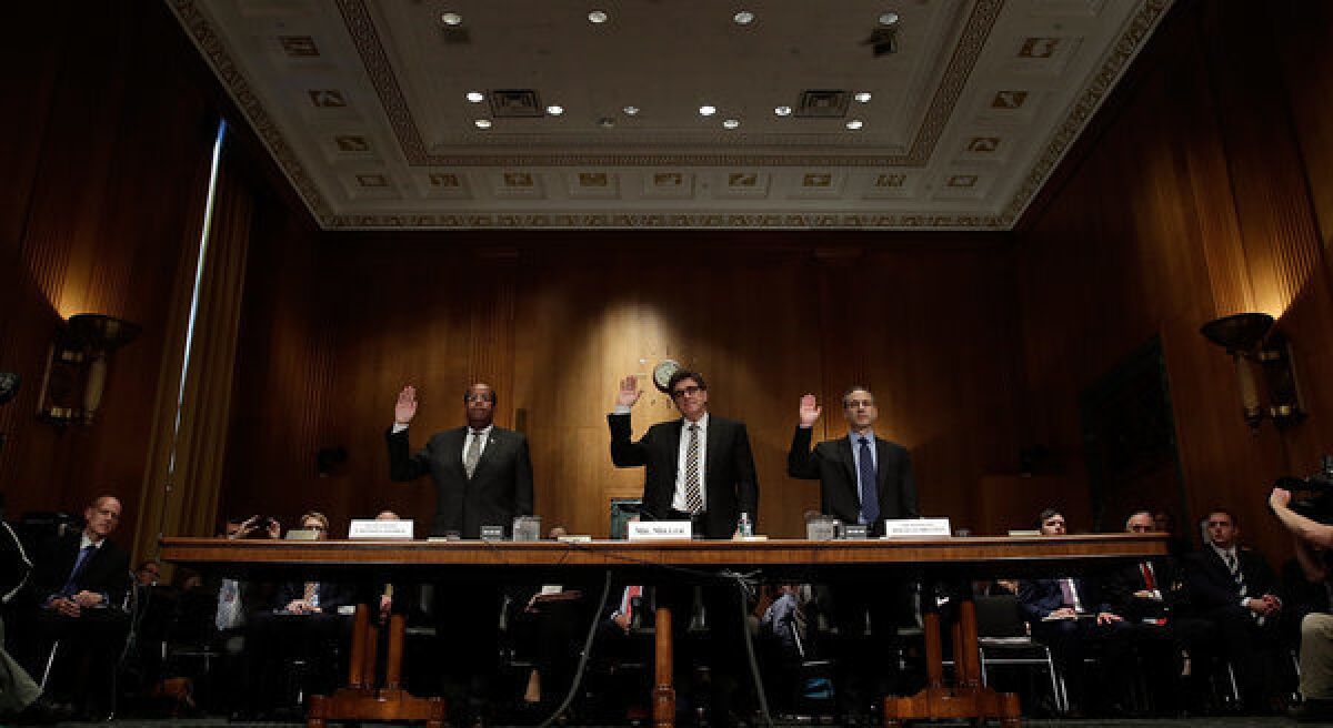 Left to right, J. Russell George, Treasury inspector general for tax administration; acting IRS Commissioner Steven T. Miller; and former IRS Commissioner Douglas Shulman are sworn in prior to testifying before the Senate Finance Committee.