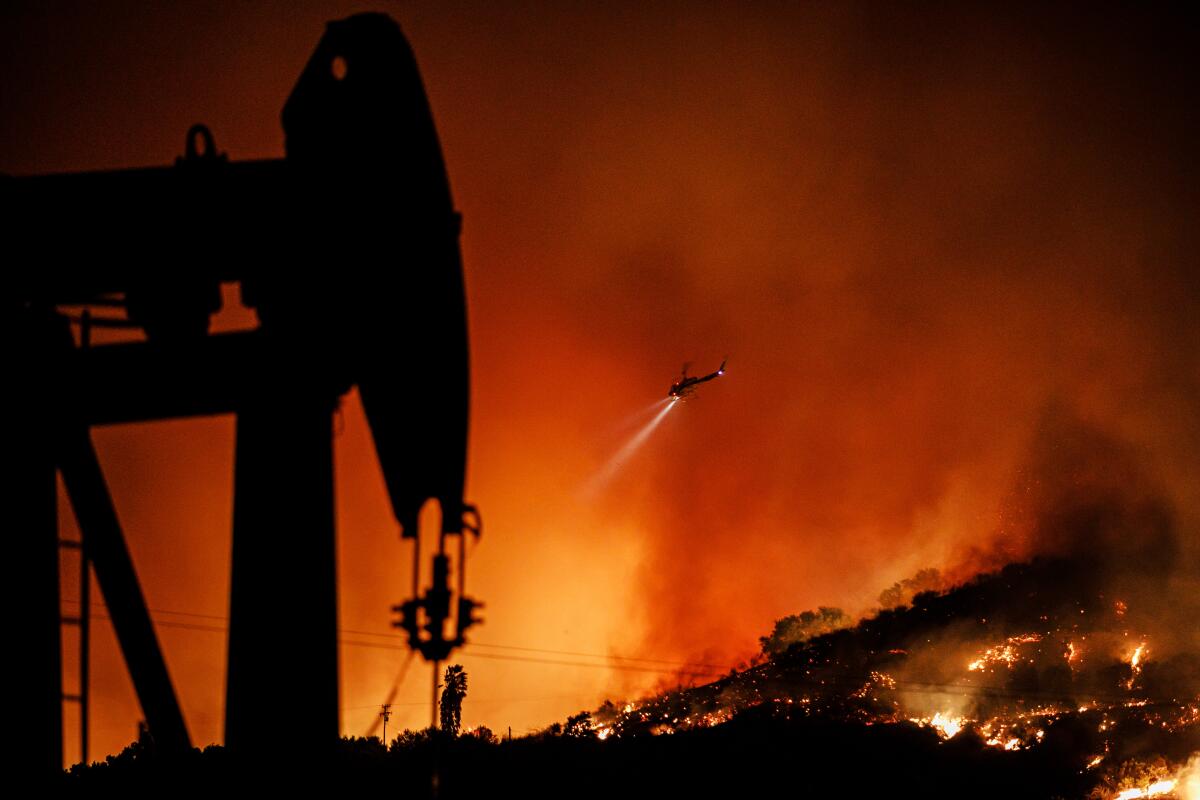 A helicopter flies over the Maria fire in Santa Paula early Friday.