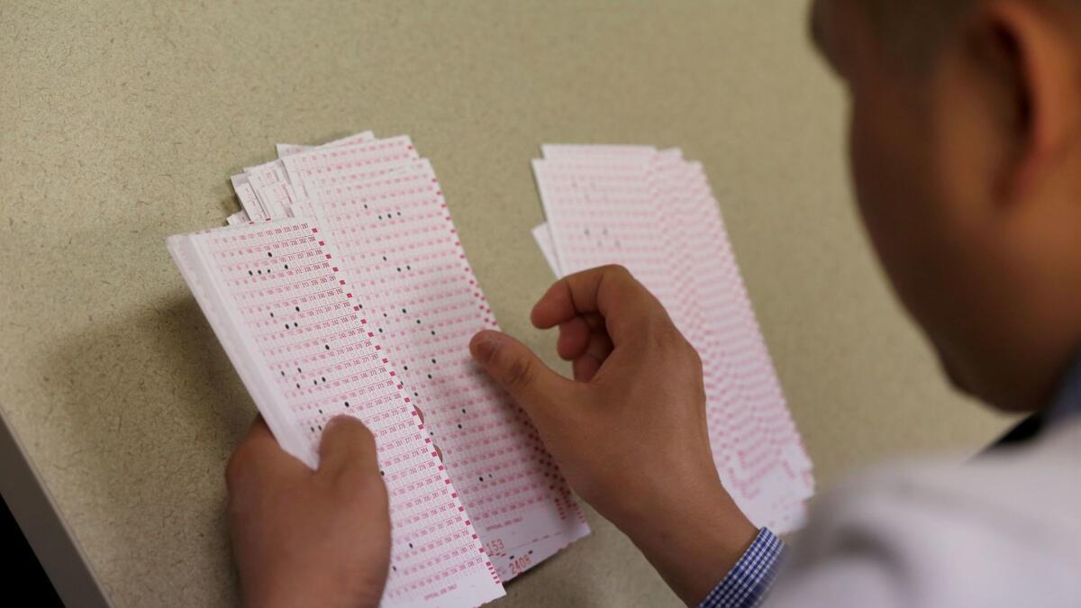 Workers prepare ballots for counting at the Los Angeles County registrar-recorder/county clerk's main office.