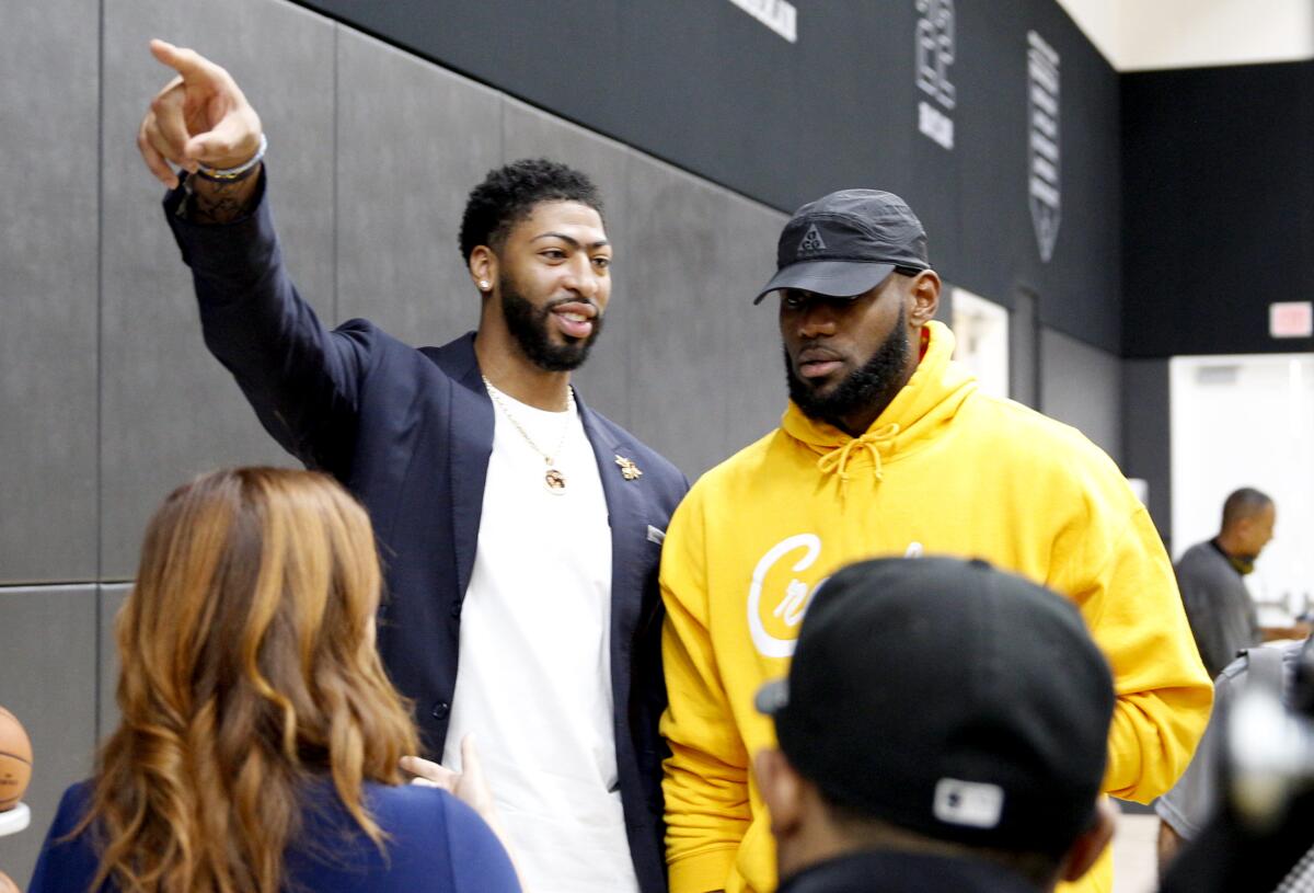 EL SEGUNDO, CALIF. -- SATURDAY, JULY 13, 2019: Anthony Davis chats with new teammate LeBron James at the UCLA Health Training Center in El Segundo, Calif., on July 13, 2019. (Marcus Yam / Los Angeles Times)