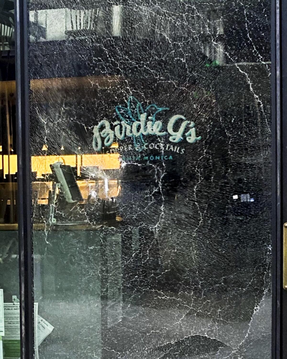 A smashed window that says "Birdie G's"