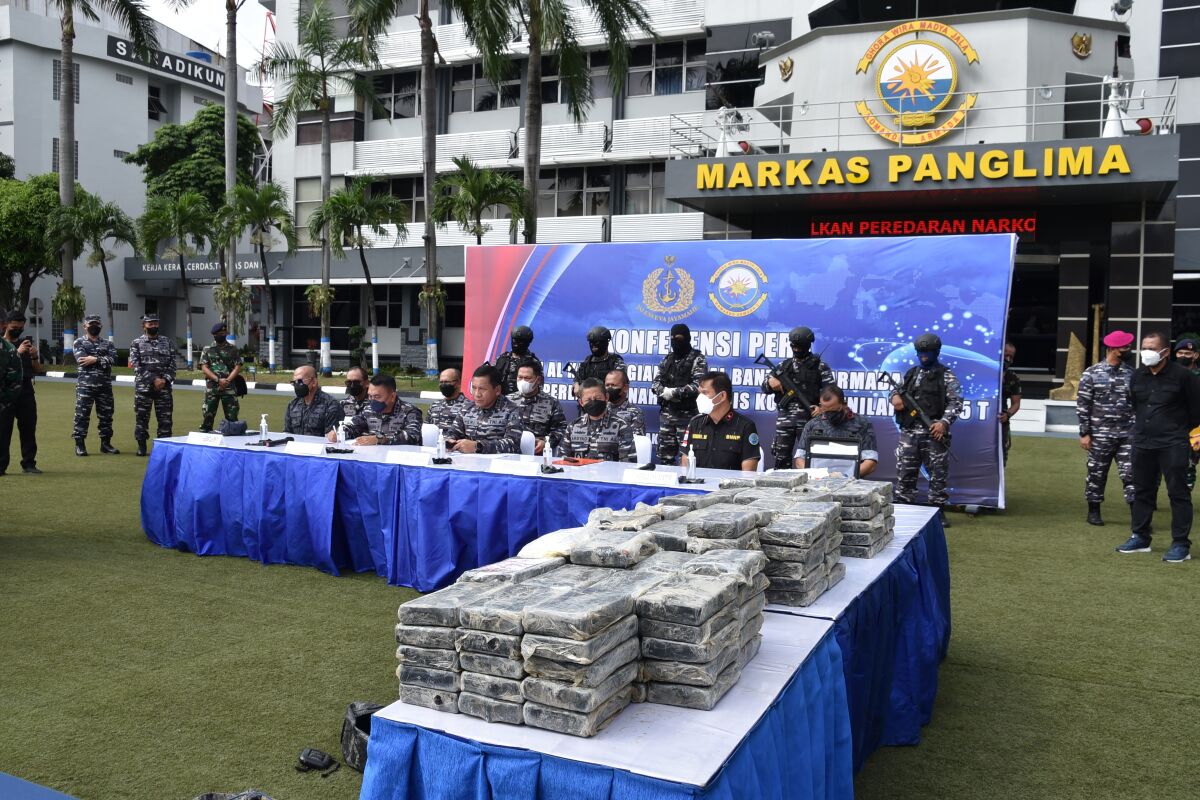 In this photo released by the Indonesian Navy, navy personnel display packages containing 179 kilograms (nearly 400 pounds) of cocaine worth of 1.2 trillion rupiah ($82.6 million) during a media conference at the Western Fleet headquarters in Jakarta, Indonesia, Monday, May 9, 2022. Sailors deployed to secure travel during the Eid al-Fitr holiday made the country's biggest cocaine seizure so far after finding the plastic packages of the drugs floating at sea, the navy said. (Indonesian Navy via AP)