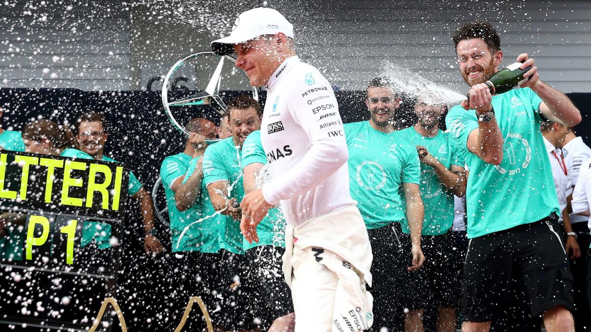 Formula One driver Valtteri Bottas celebrates with his Mercedes team members after winning the Austrian Grand Prix on Sunday.