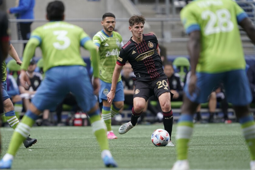 Atlanta United midfielder Emerson Hyndman (20) looks to pass against the Seattle Sounders during the first half of an MLS soccer match, Sunday, May 23, 2021, in Seattle. (AP Photo/Ted S. Warren)