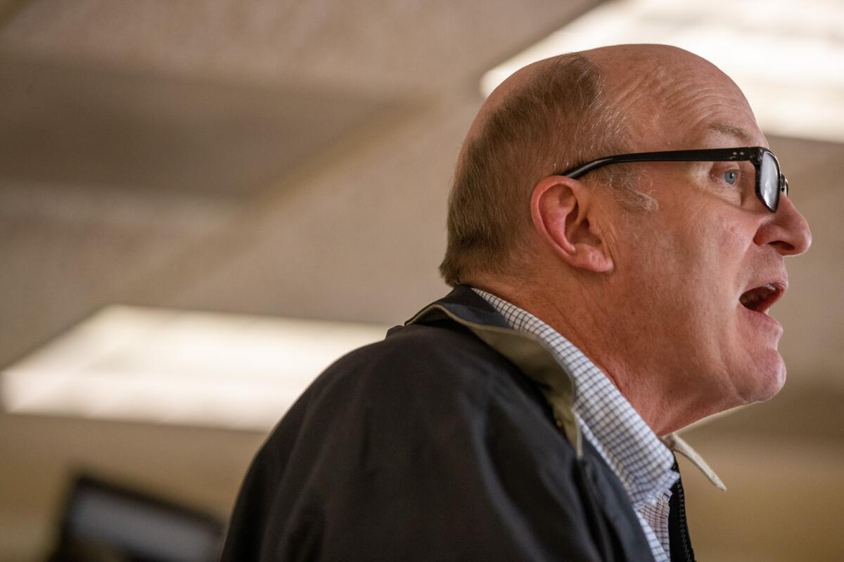 A profile view of union co-president Kurt Petersen in glasses, a button-up shirt and a jacket