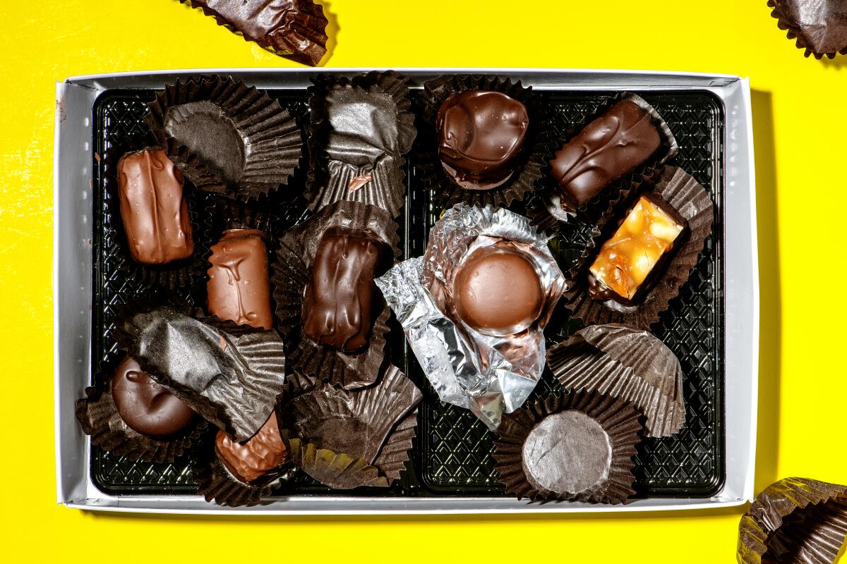 A box of See's Candies and their empty wrappers