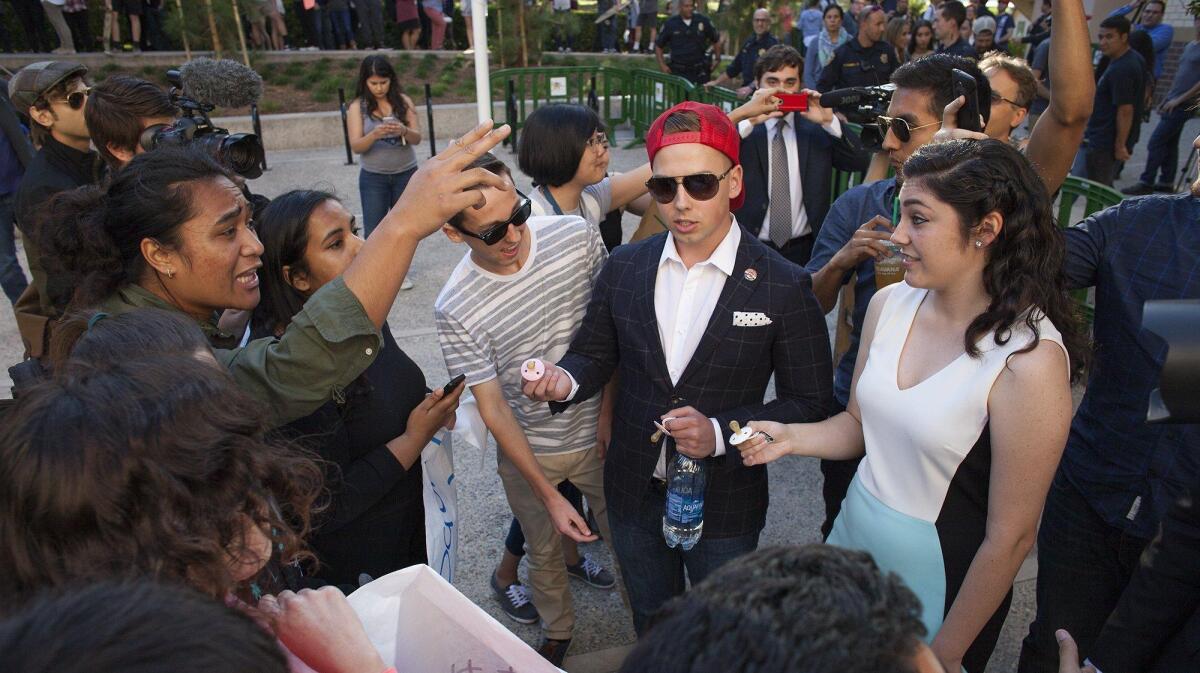 UC Irvine College Republicans, right, face off with protesters before an event featuring speaker Milo Yiannopoulos, tech editor for the conservative news site Breitbart, at UC Irvine in June. Expect to see more such clashes this year, columnist Patrice Apodaca writes.