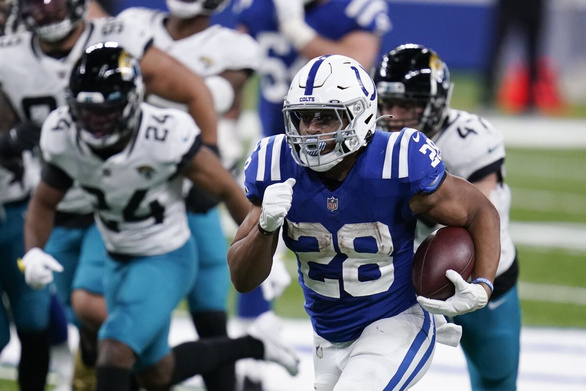 Indianapolis Colts' Jonathan Taylor (28) runs for a touchdown during the second half of an NFL football game against the Jacksonville Jaguars, Sunday, Jan. 3, 2021, in Indianapolis. (AP Photo/Michael Conroy)