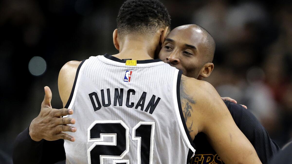 NBA legends Tim Duncan and Kobe Bryant embrace before a game in San Antonio last season.
