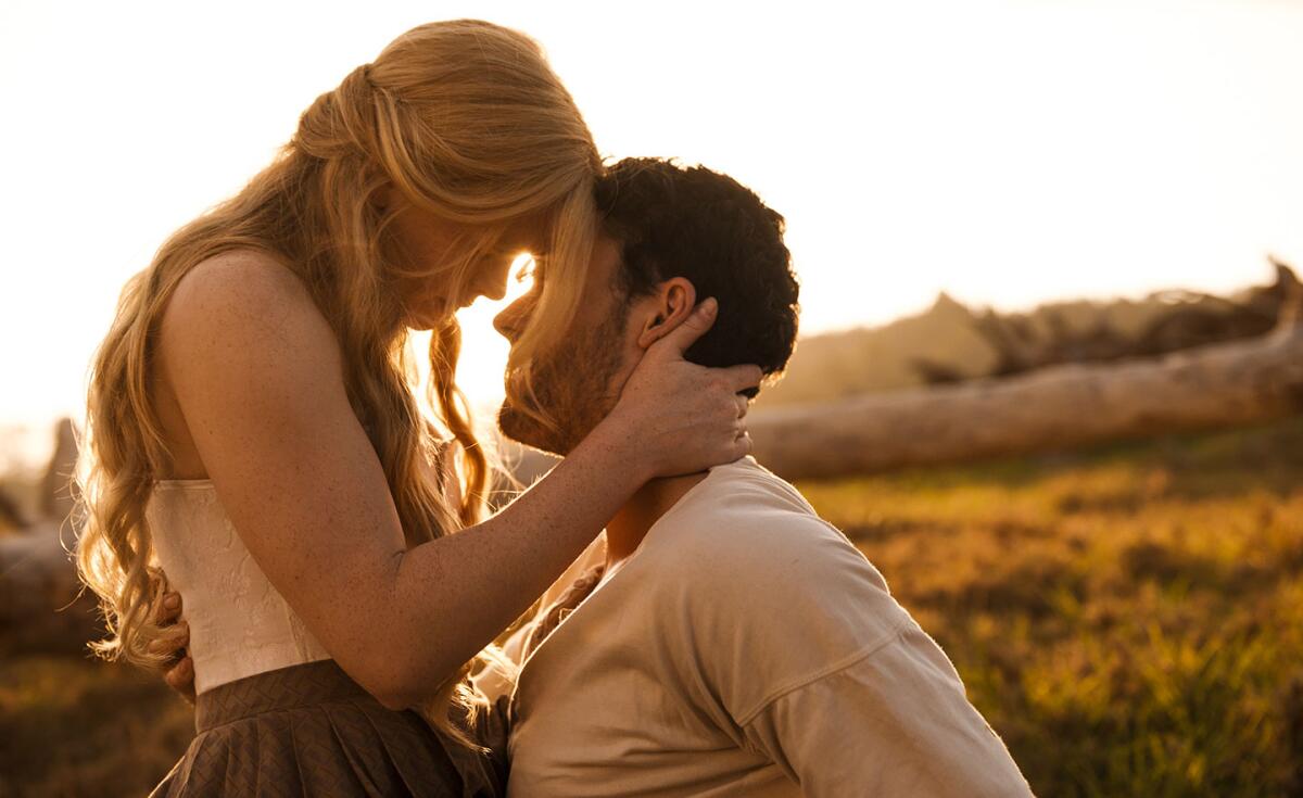 A woman and a man embrace outdoors in the movie “Redeeming Love.”