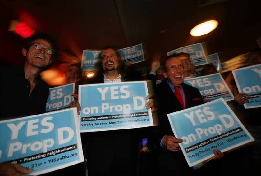 Supporters of Proposition D celebrate its early lead at the Lucky Strike bowling alley in Hollywood. The measure would limit marijuana shops in L.A. to those open before the adoption of a failed moratorium in 2007.