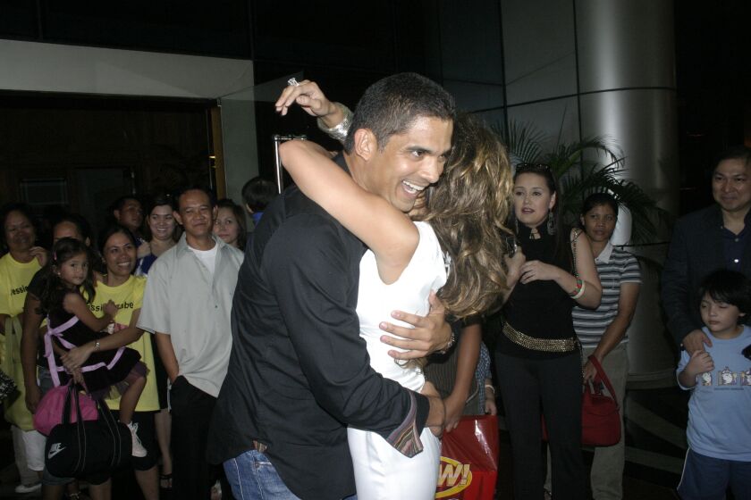 2007 photo of David Bunevacz embracing his wife, Jessica Rodriguez, during a showbiz event.