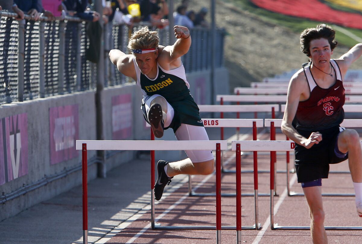 Edison's Jeff Ciccarelli, left, competes in the boys' 110-meter hurdles in the Orange County track and field championships.