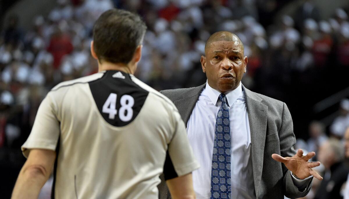 Clippers Coach Doc Rivers speaks with referee Scott Foster (48) in the first quarter of Game 3.